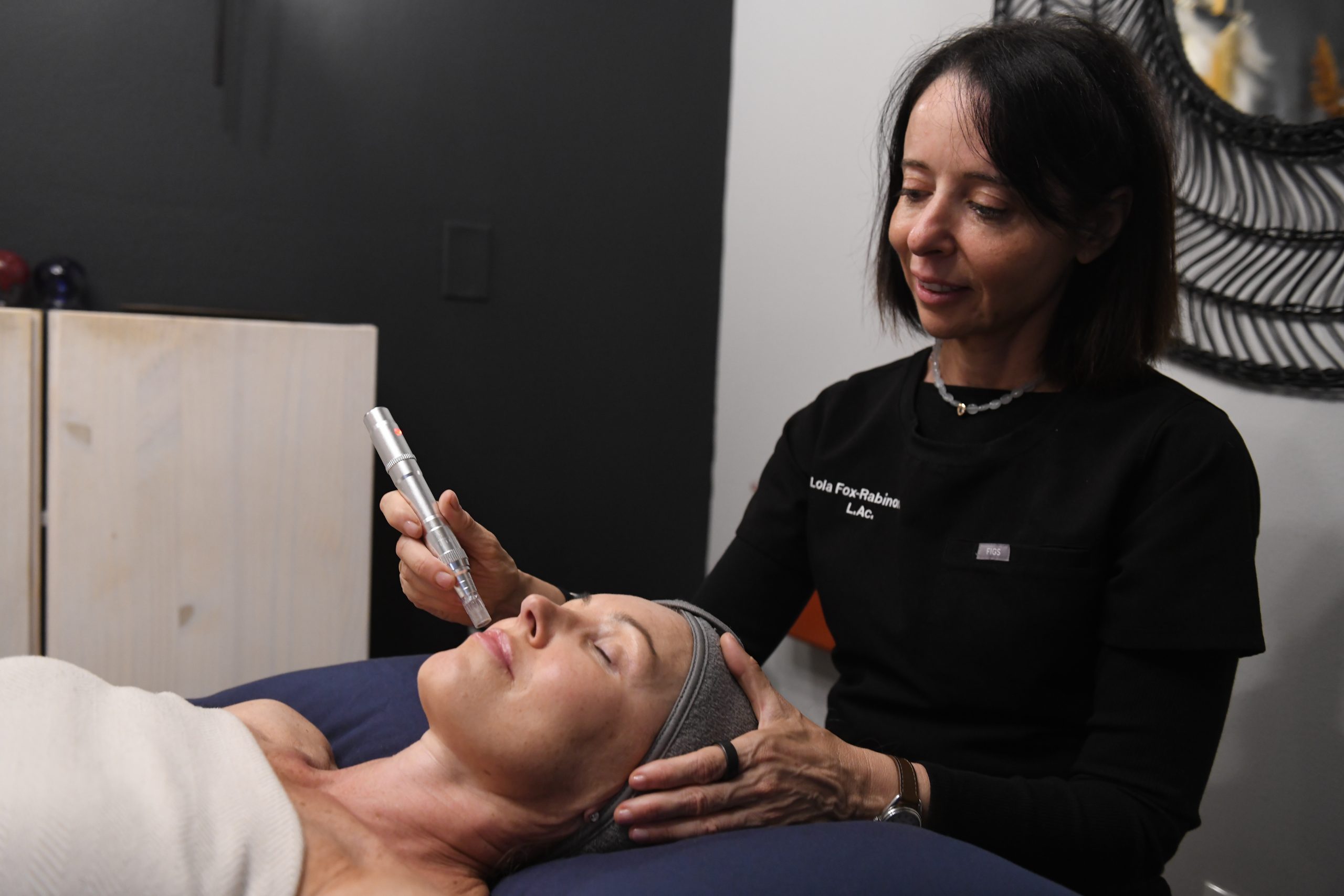 Lola Fox-Rabinovich, a licensed acupuncturist, microneedling patient's face in Santa Monica